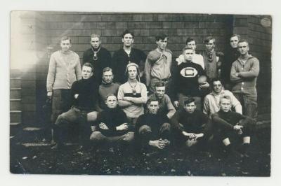 Group of football players posing for a photograph postcard