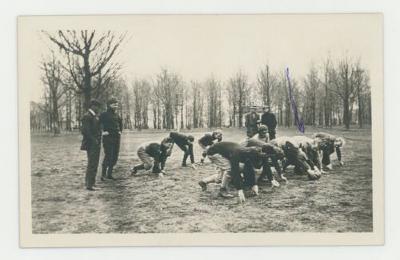 Football players about to run a play postcard