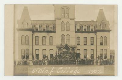 Individuals in front of the Old Main building postcard