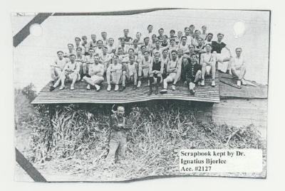 St. Olaf College track team sitting on a roof postcard