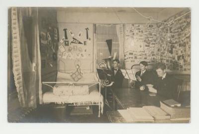 Three musicians practicing in a dorm room postcard