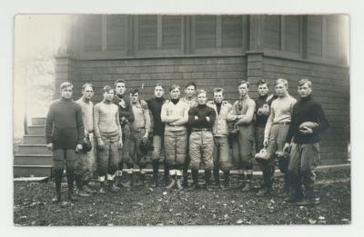 Group of football players outside of a building postcard