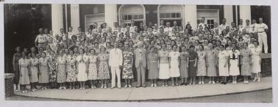 Group of men and women with F. Melius Christiansen standing in front center