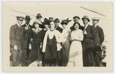 Individuals posing for a photograph on a boat postcard