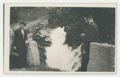 Graduates posing in front of a river postcard