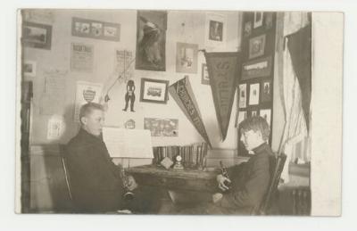 Two musicians practicing in a dorm room postcard