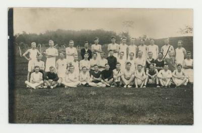 St. Olaf College men's cross country team in a field postcard