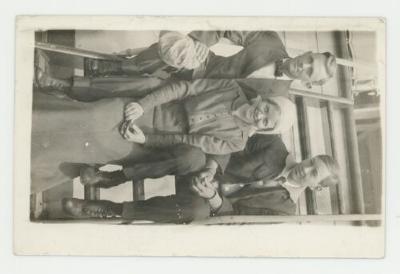 Individuals on a boat stairwell postcard