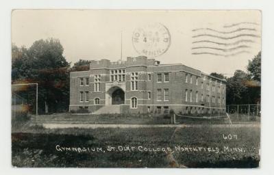 Outdoor tennis court in front of the gymnasium postcard