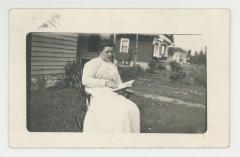 Woman reading a book postcard