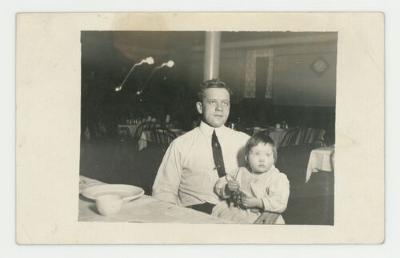 Man holding a baby postcard