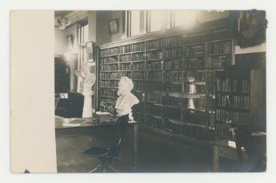 Shelves of books in Steensland Library postcard